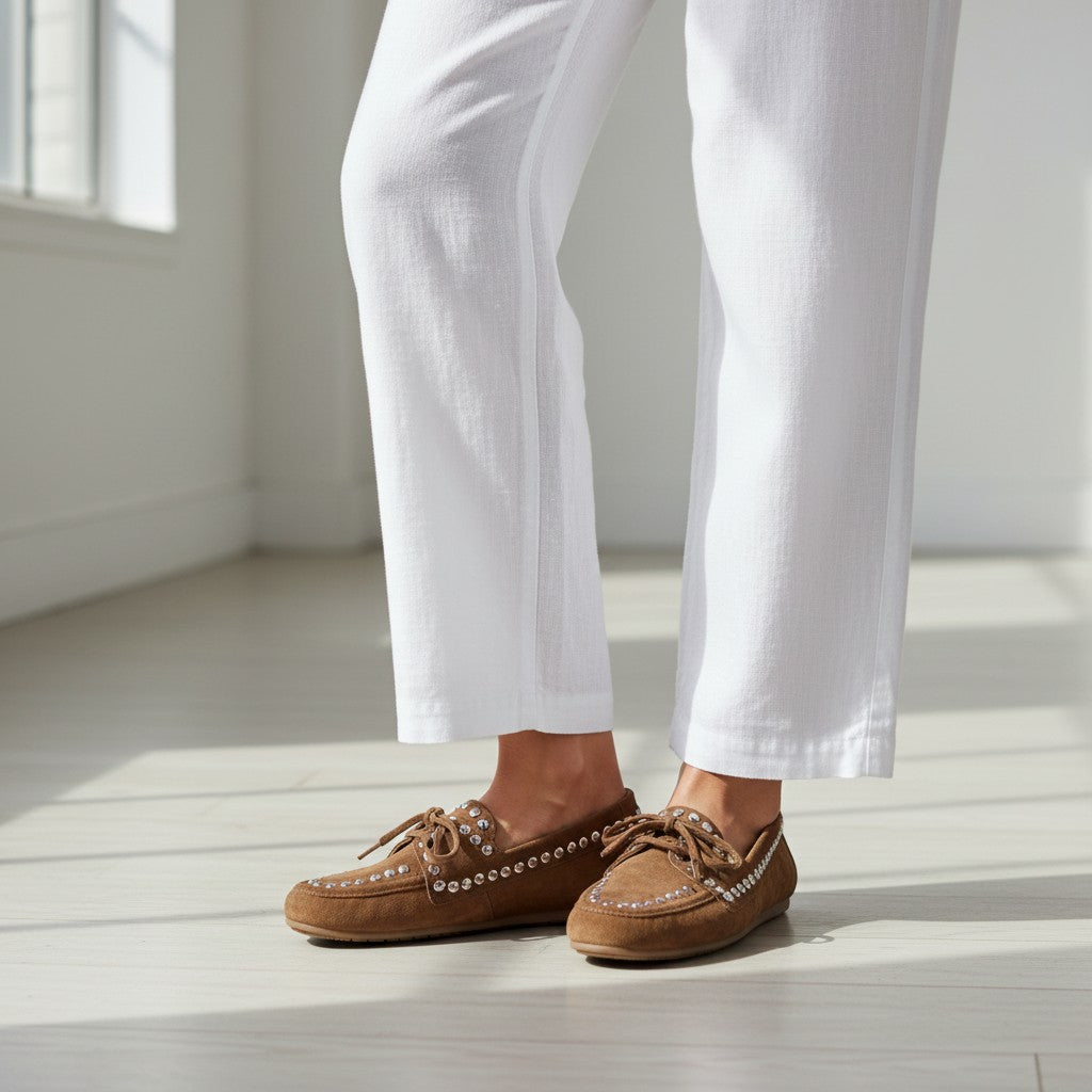 Mocasines de ante cognac de tretze-shoes con tachuelas plateadas y cordones. Diseño plano y cómodo.
